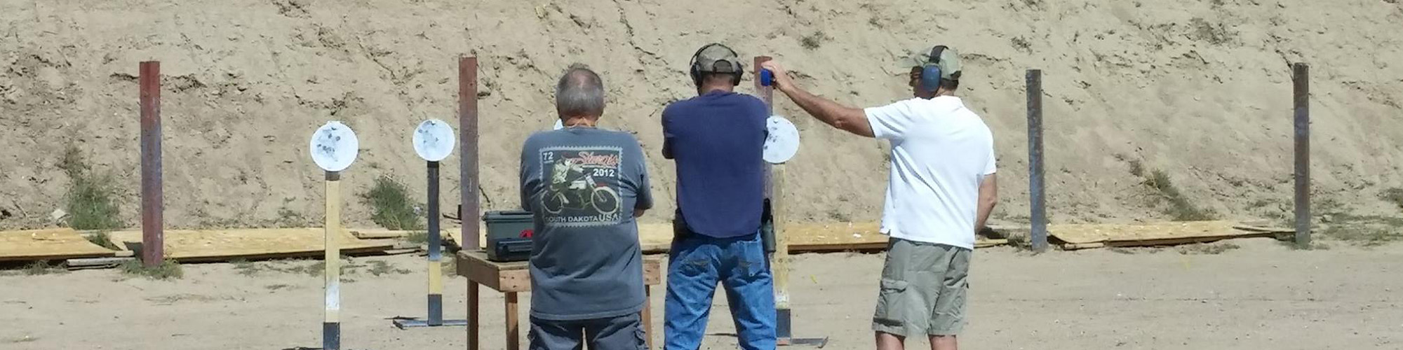 men shooting pistol targets